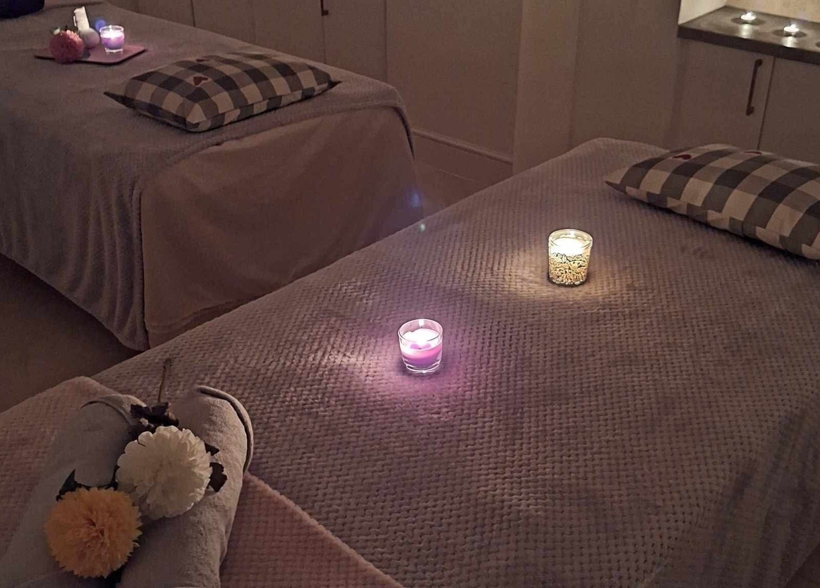 Relaxing massage room setup with candles at Finn Spa in Manchester, Chadderton, England, GB.