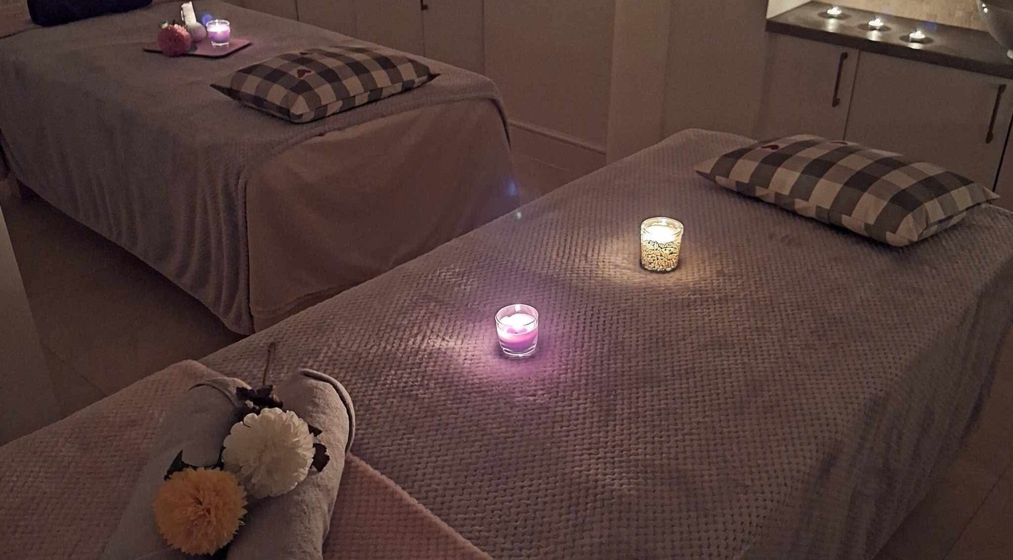 Relaxing massage room setup with candles at Finn Spa in Manchester, Chadderton, England, GB.
