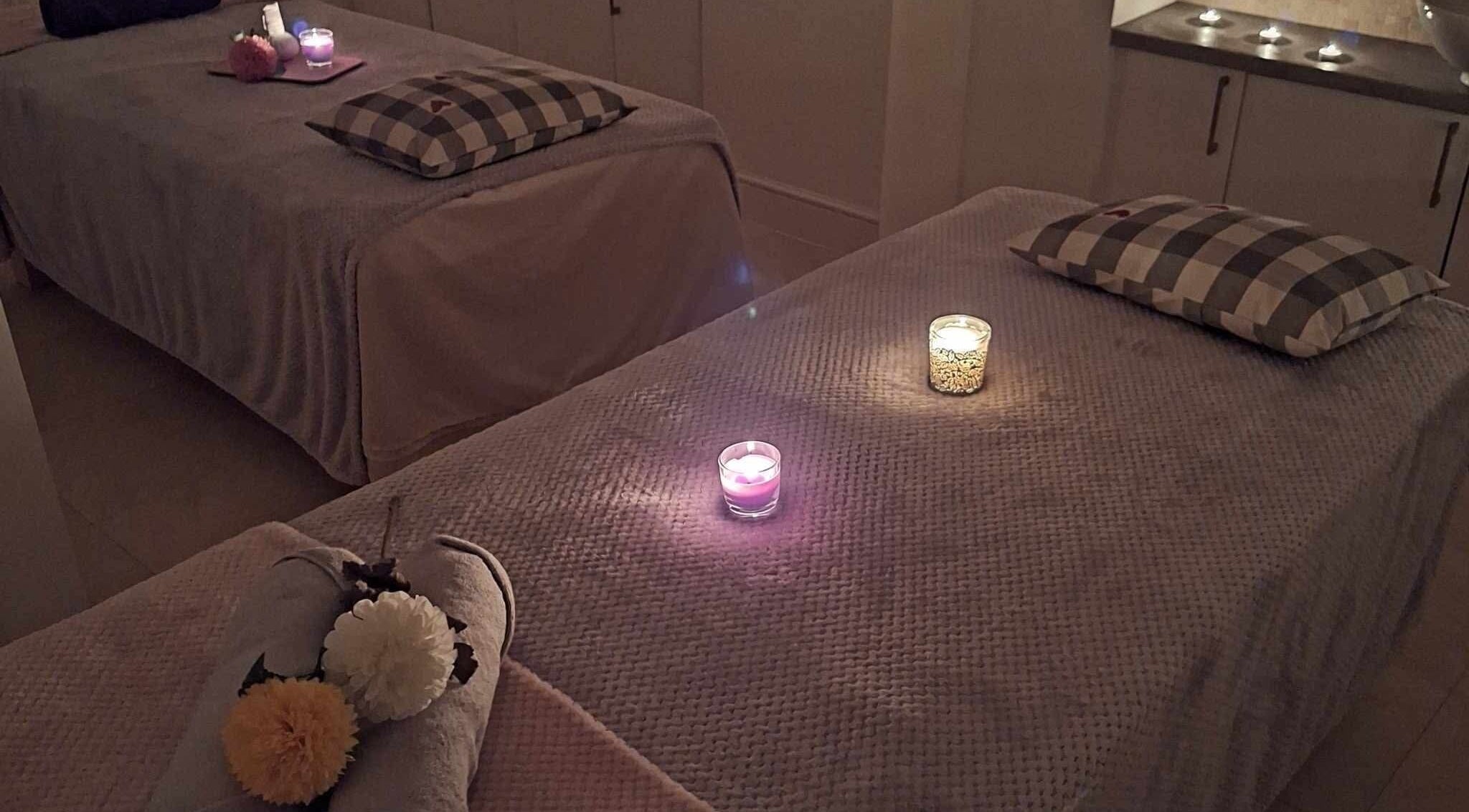 Relaxing massage room setup with candles at Finn Spa in Manchester, Chadderton, England, GB.