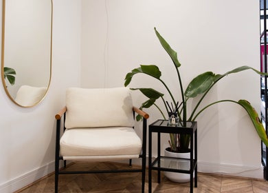 Cozy corner at Furious Filer at Gosh Gosh PMU Clinic, London, England, GB with armchair and plant.