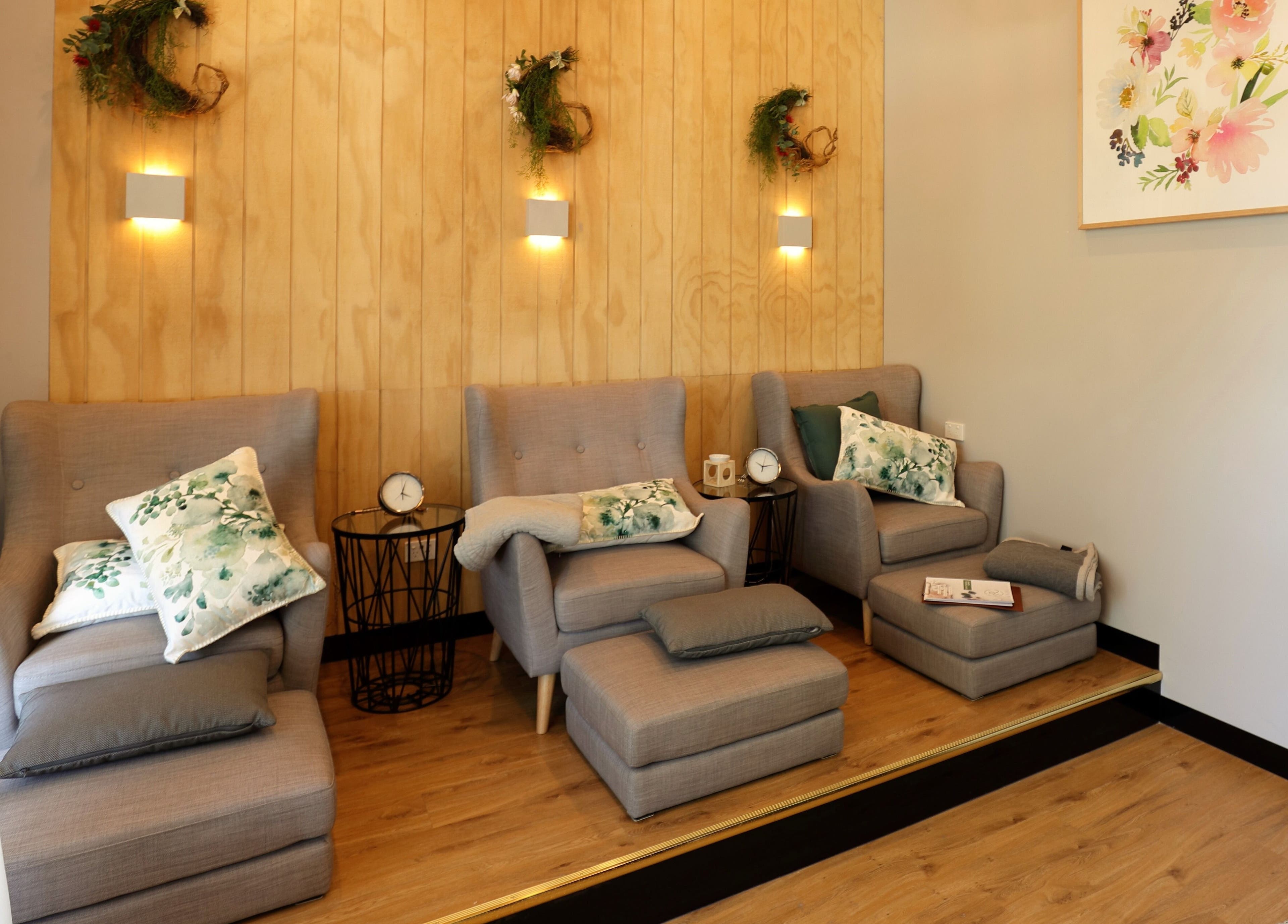 Cozy seating area at Retreat Massage and Wellness in Southport, Queensland, AU with plush chairs and decor.