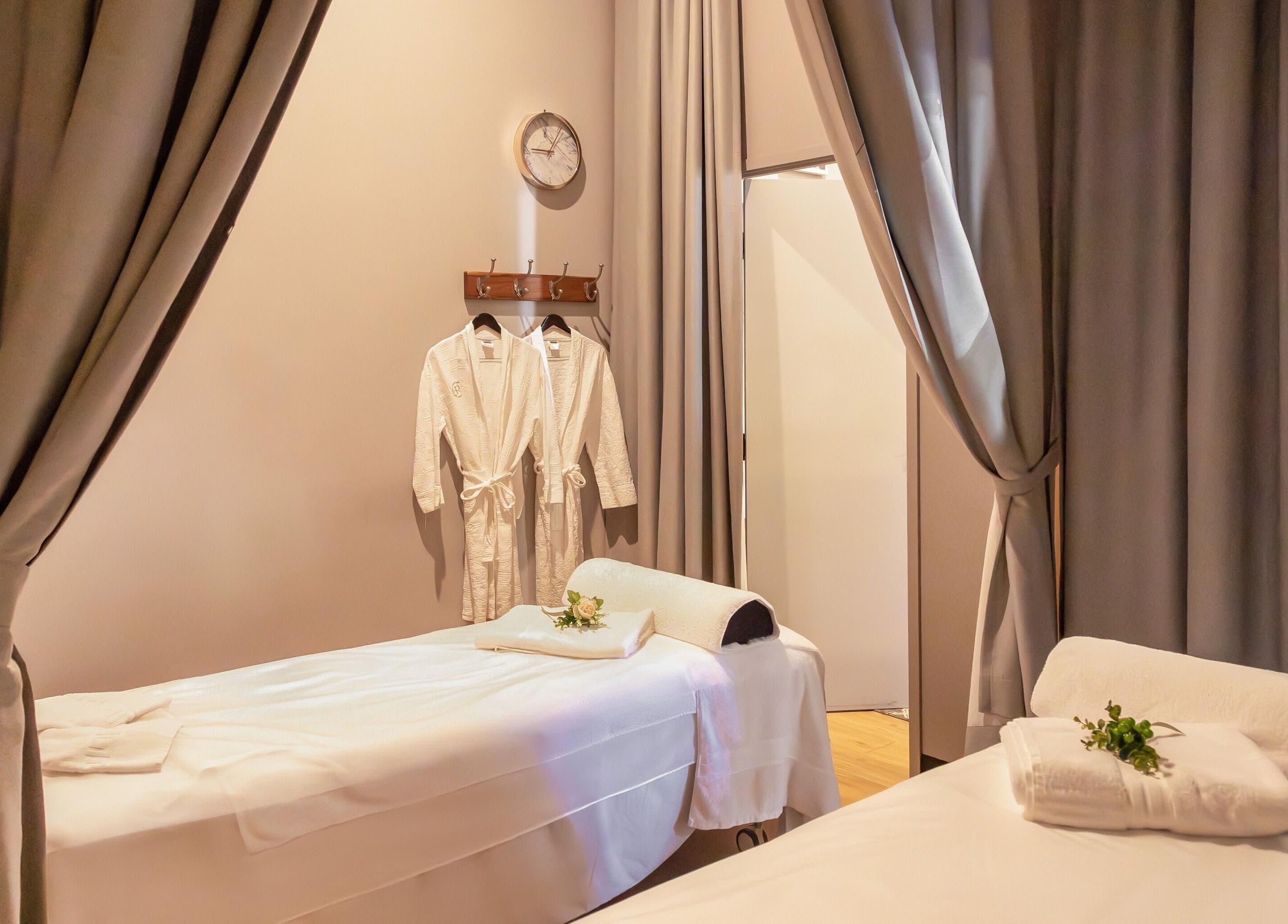 Relaxing massage room at Retreat Massage and Wellness, Southport, Queensland, AU with cozy beds and robes.