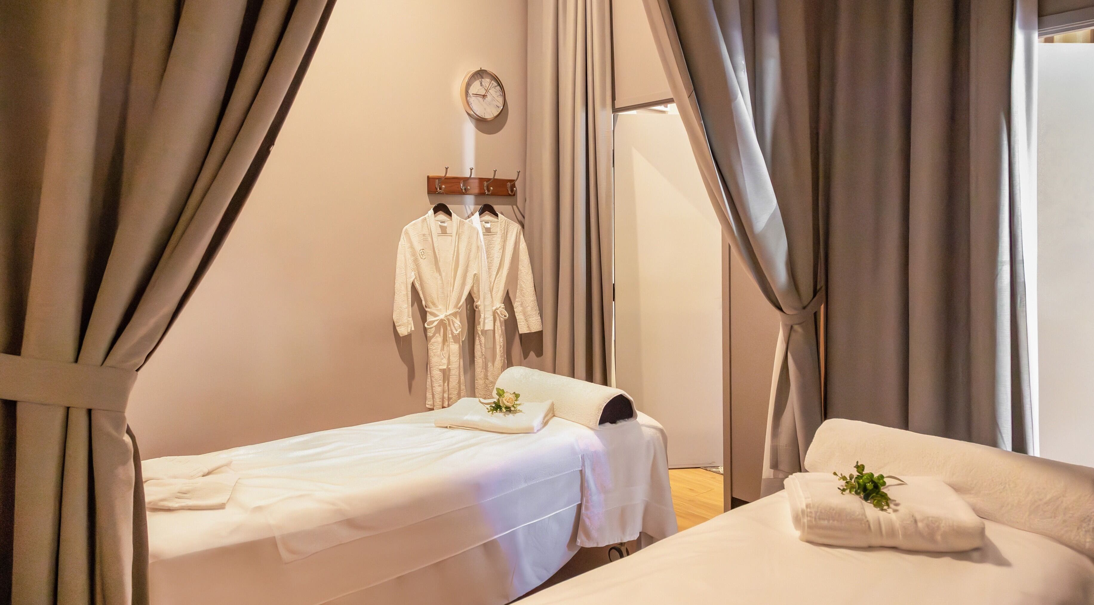 Relaxing massage room at Retreat Massage and Wellness, Southport, Queensland, AU with cozy beds and robes.