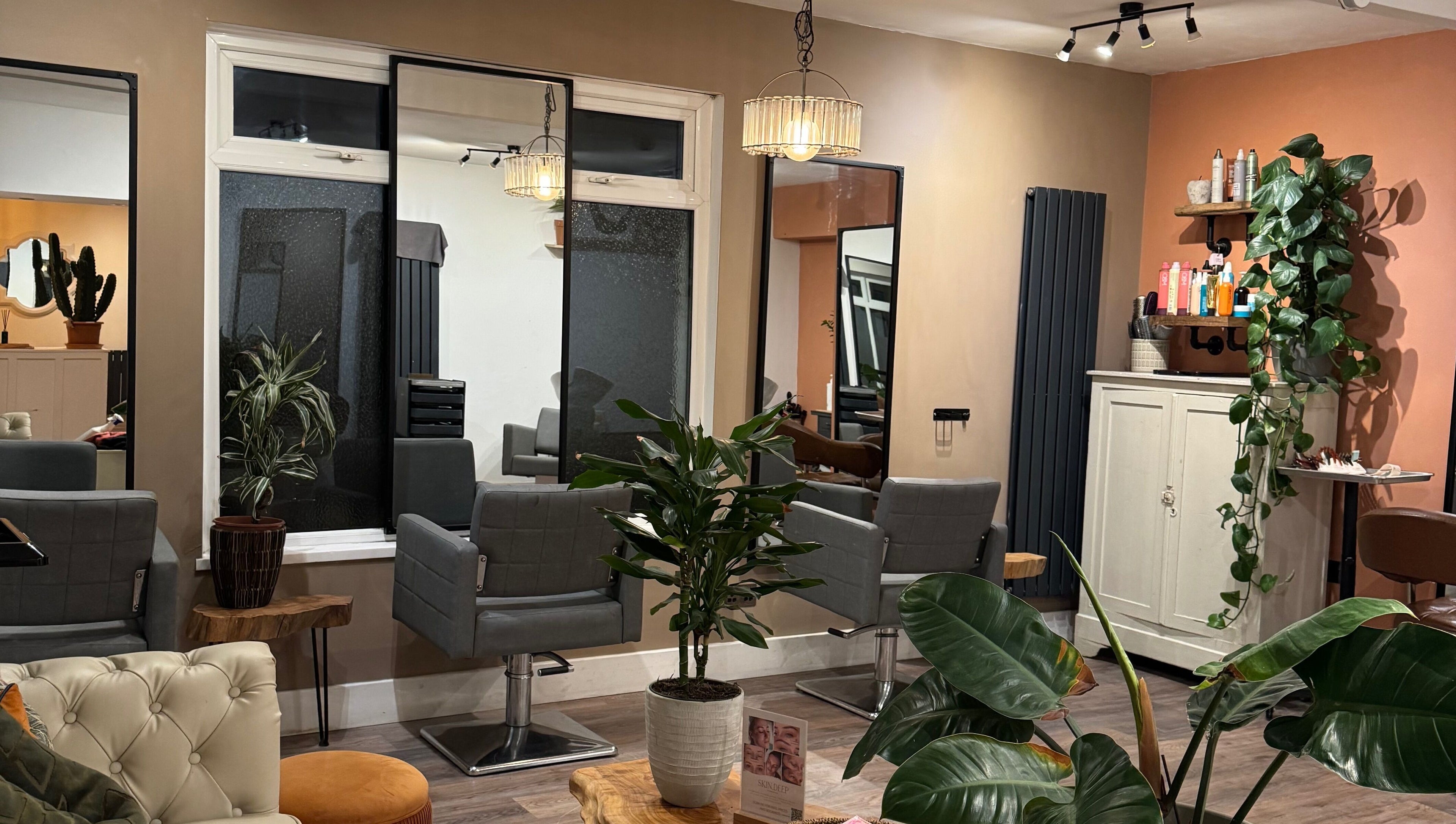 Stylish beauty salon interior at Megan Duffy Artistry in Par, England, GB, featuring modern decor and plants.