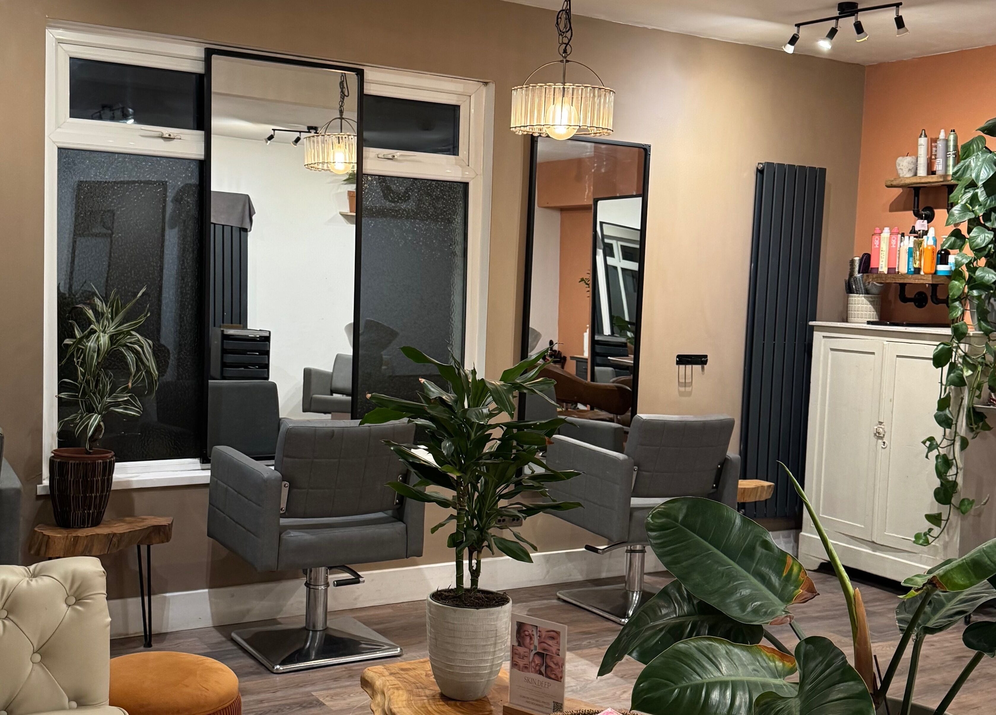 Stylish beauty salon interior at Megan Duffy Artistry in Par, England, GB, featuring modern decor and plants.