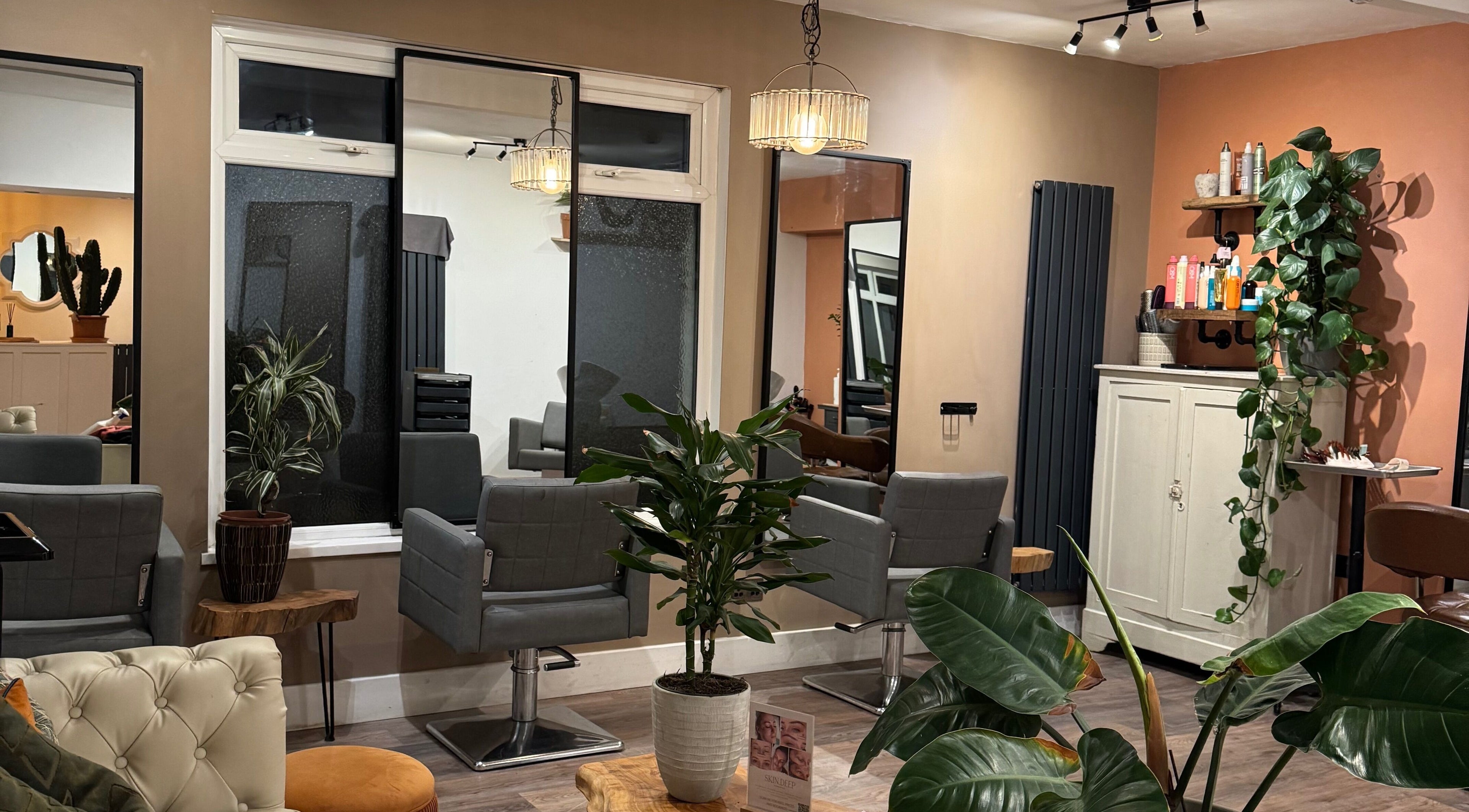 Stylish beauty salon interior at Megan Duffy Artistry in Par, England, GB, featuring modern decor and plants.