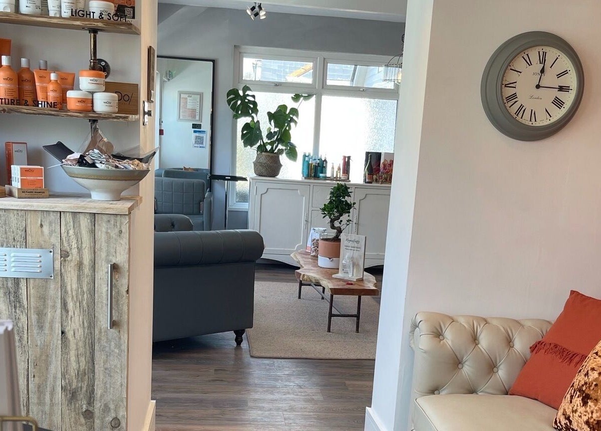 Warm lounge area at Megan Duffy Artistry, Par, England, GB, showcasing stylish interior and beauty products.