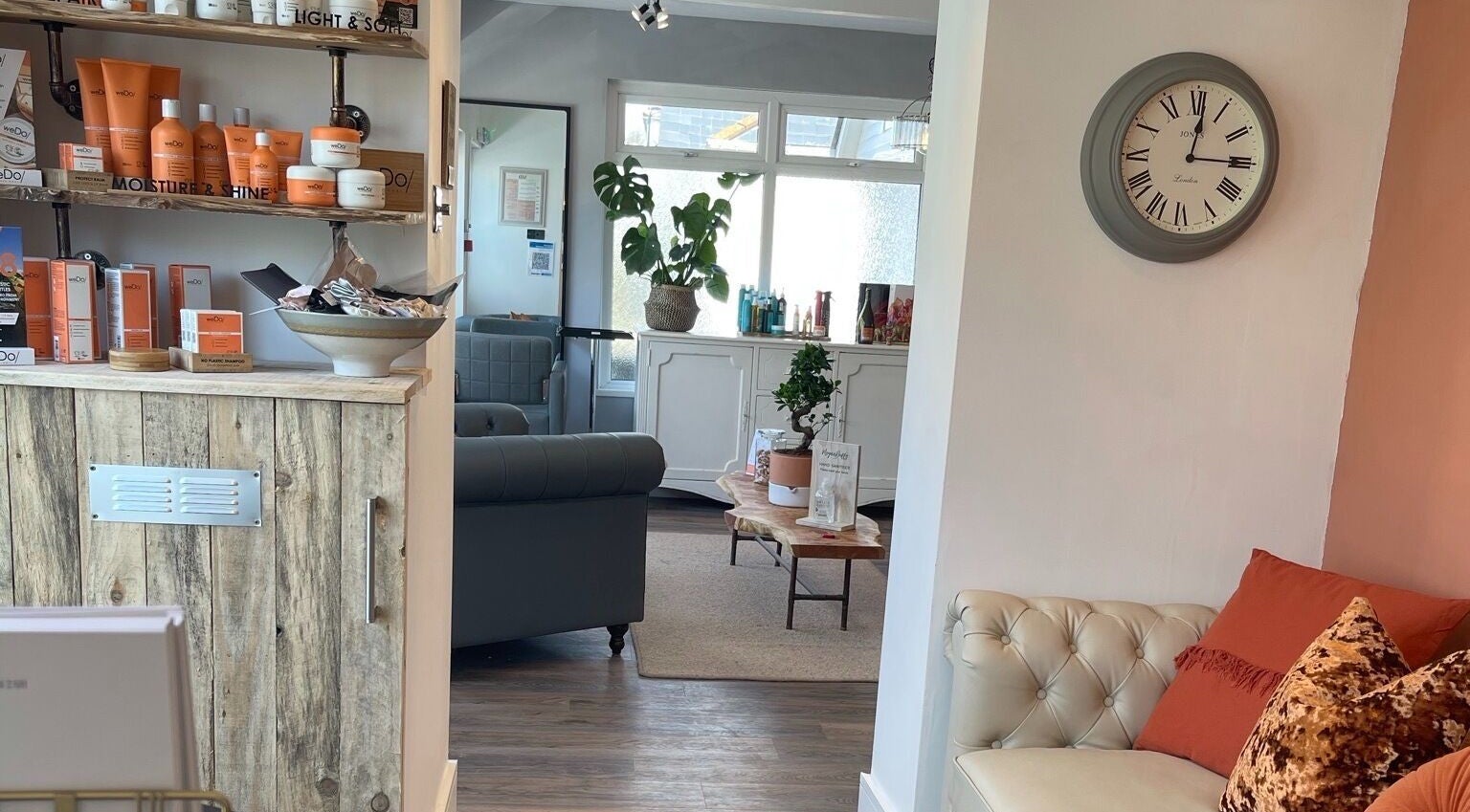 Warm lounge area at Megan Duffy Artistry, Par, England, GB, showcasing stylish interior and beauty products.