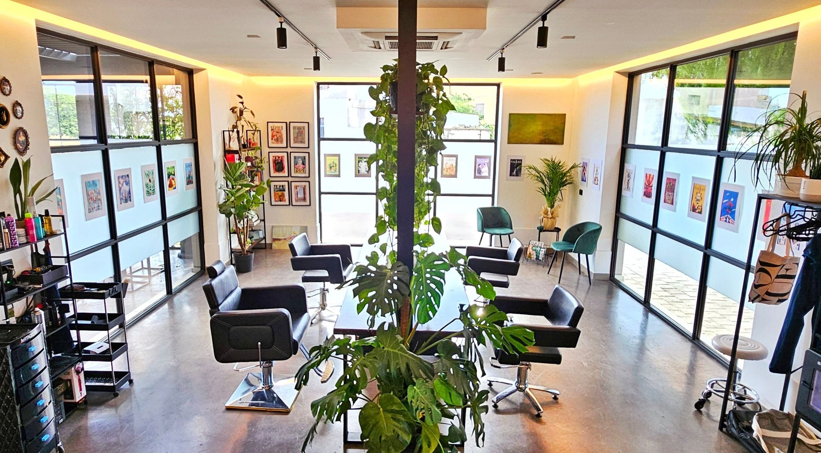 Interno moderno del KAMM hairsalon, Galatone, Puglia, IT, con poltrone eleganti e piante verdi.
