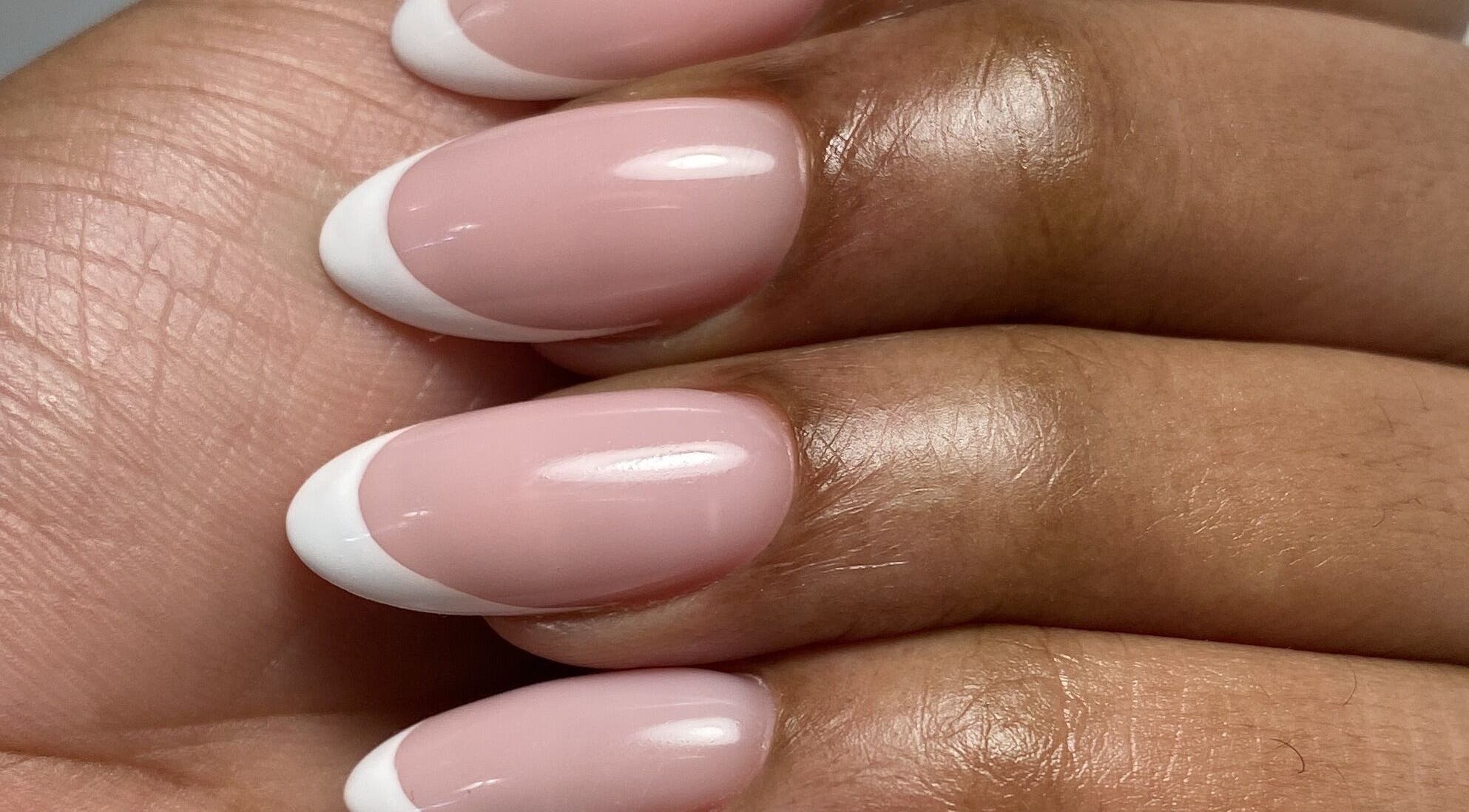 French manicure at Yuliia Nails in Paris, Île-de-France, FR showcasing elegant pink and white tips.