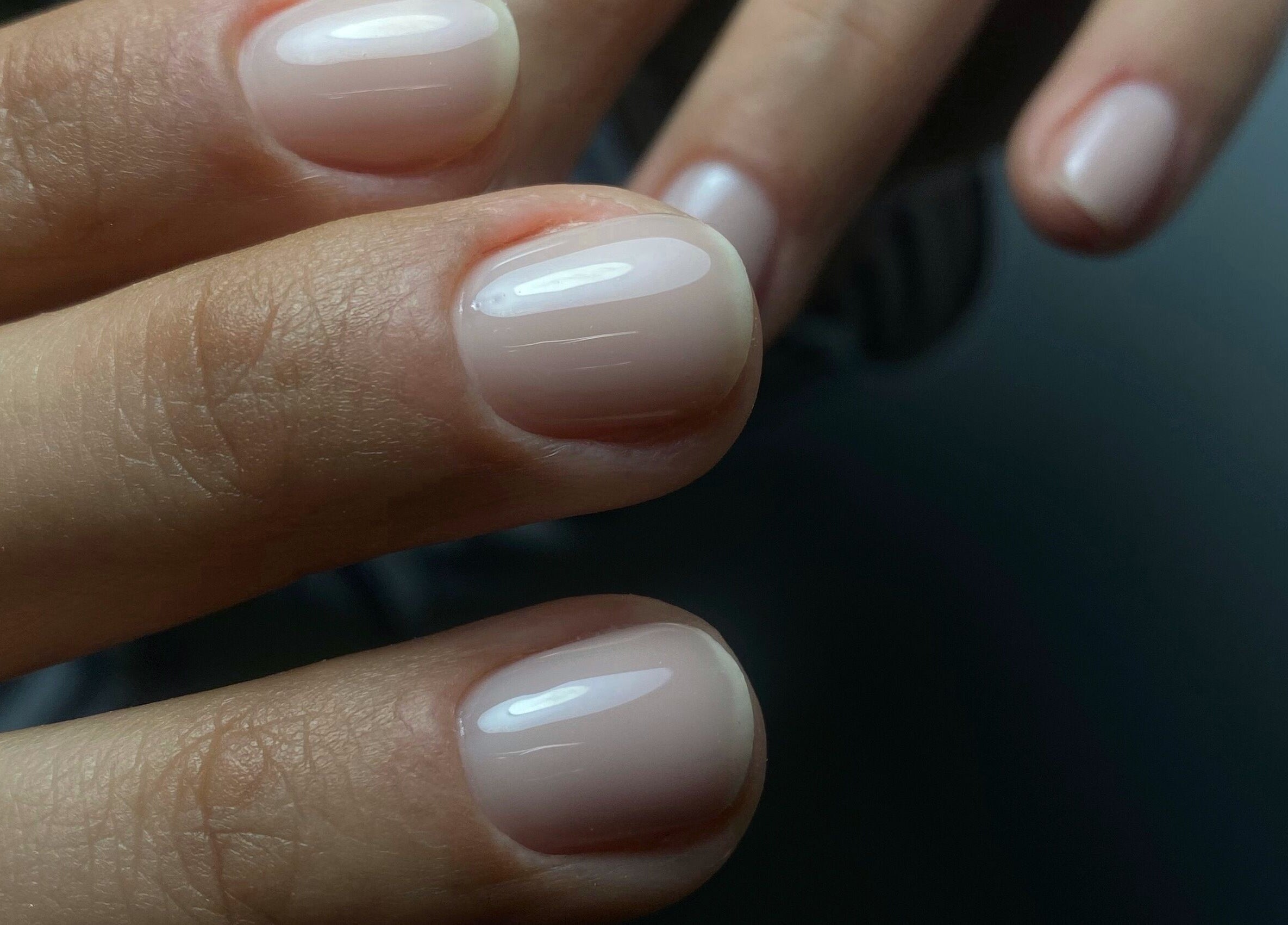 Beautifully manicured hands at Yuliia Nails, Paris, Île-de-france, FR, showcasing glossy pale pink polish.