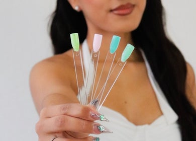 A woman displays a colorful nail palette at nailed.byvaeh, Tulare, California, US.