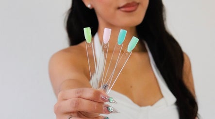 A woman displays a colorful nail palette at nailed.byvaeh, Tulare, California, US.
