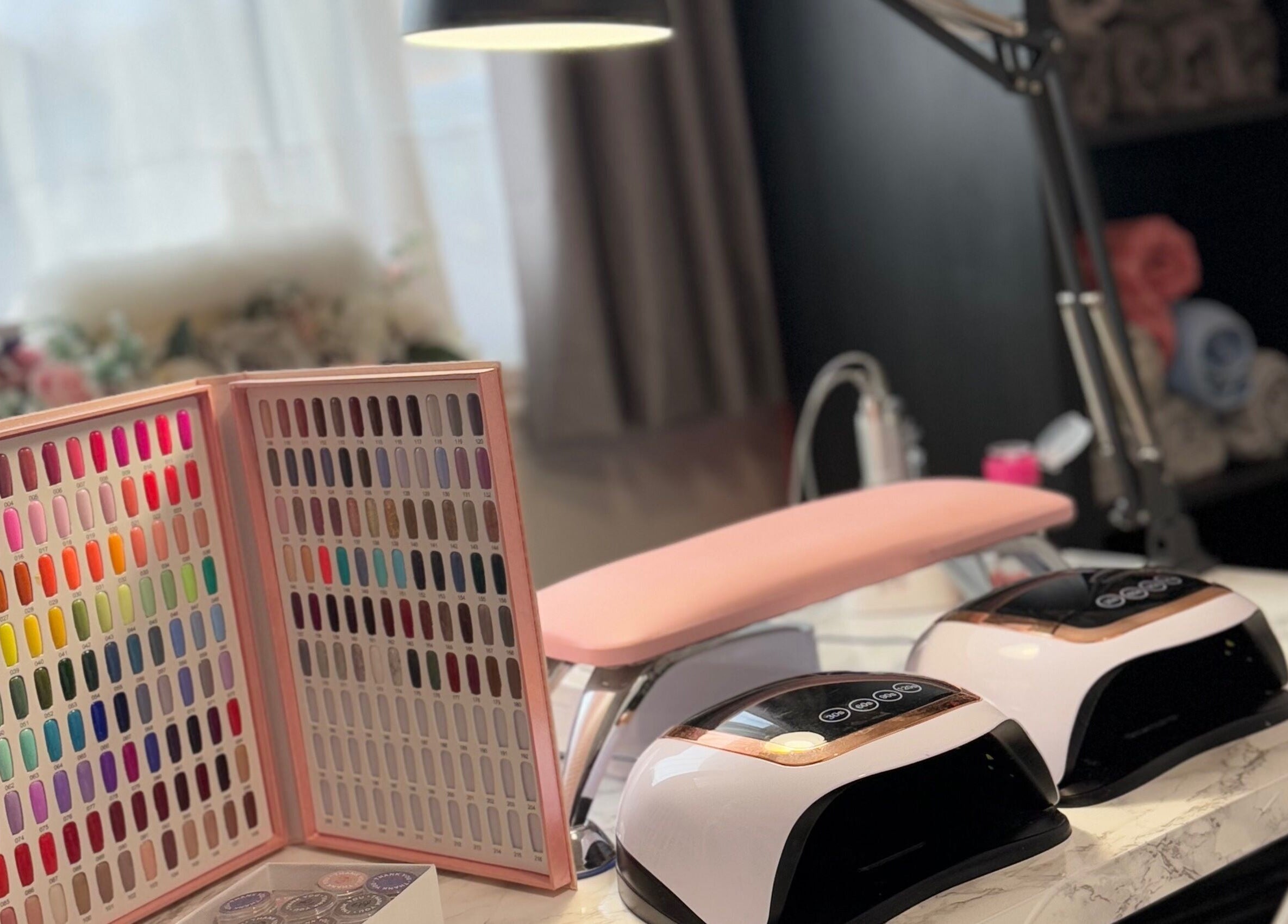 Nail station at TC Sports Therapy and Massage in Heelands, England, GB with vibrant color chart and UV lamps.