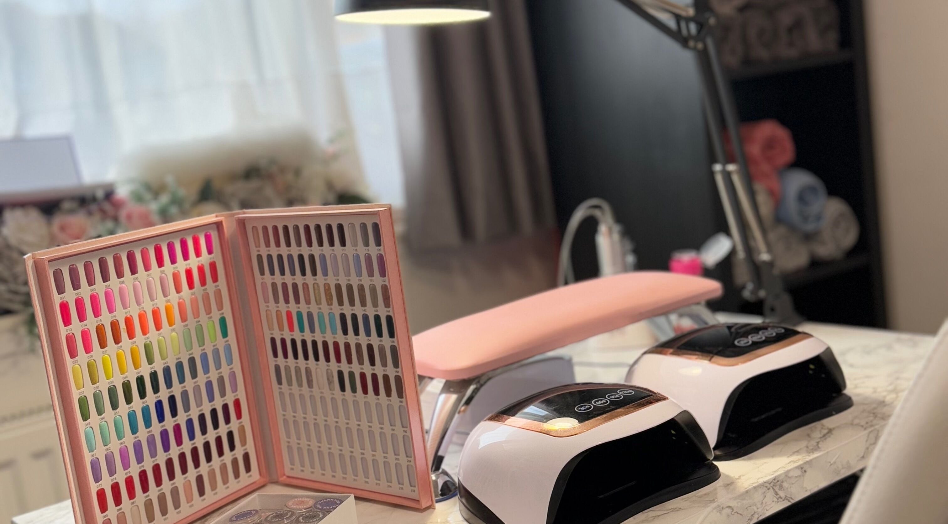 Nail station at TC Sports Therapy and Massage in Heelands, England, GB with vibrant color chart and UV lamps.