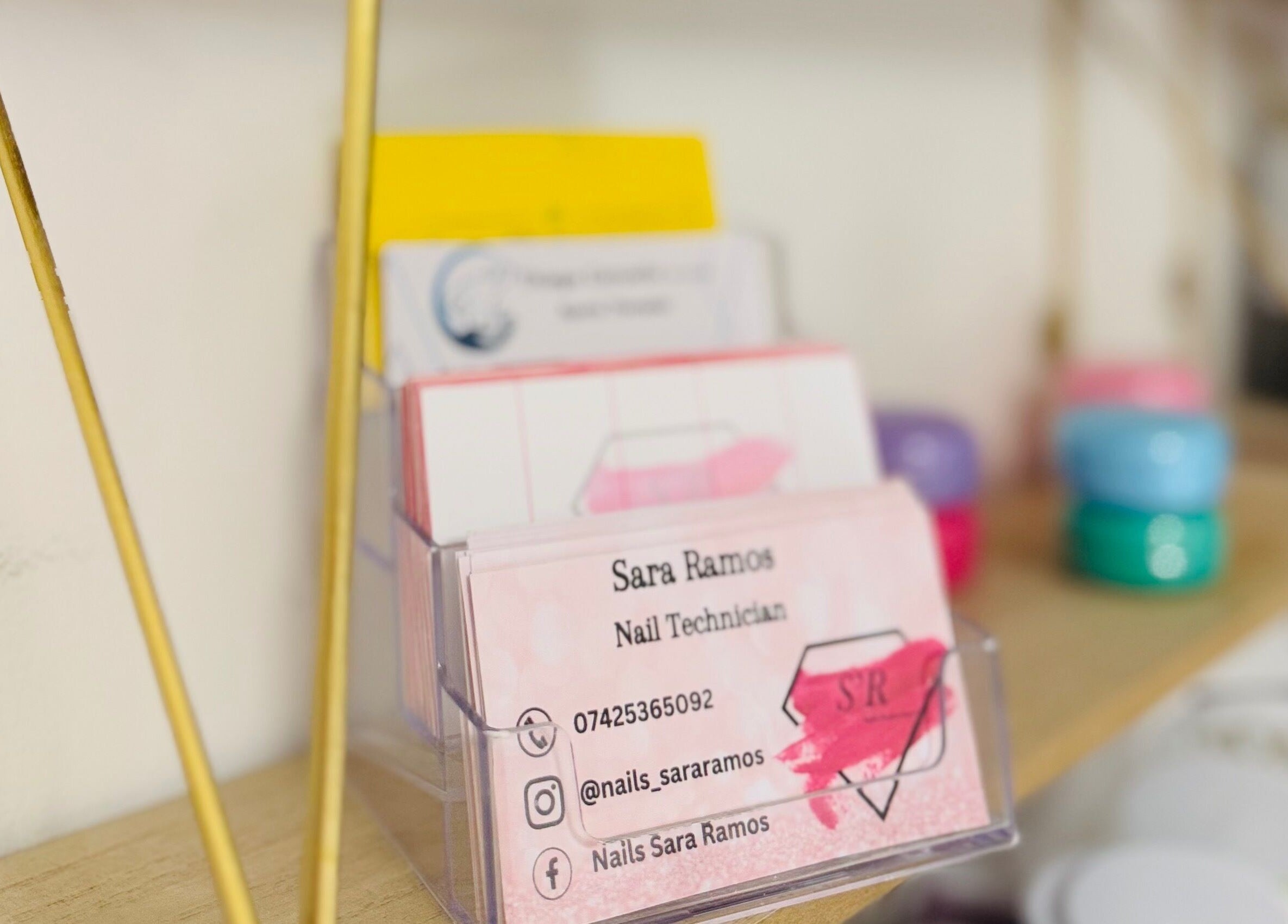 Business cards on a shelf at TC Sports Therapy and Massage, Heelands, England, GB.