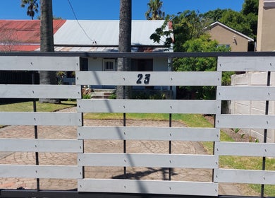 Entrance gate of Izelke's Sculpt and Glow Studio, Cape Town, Western Cape, ZA with house in background.