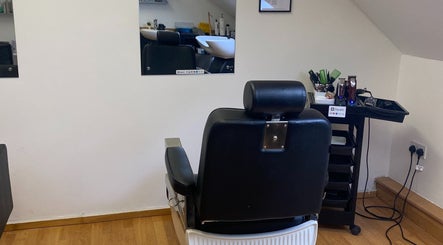 Cozy styling area at Reece Goldsmith Hairdressing in Swineshead, England with a mirror and black chair.