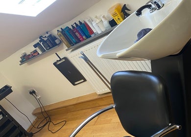 Washing area at Reece Goldsmith Hairdressing in Swineshead, England, GB with modern sink and styling products.