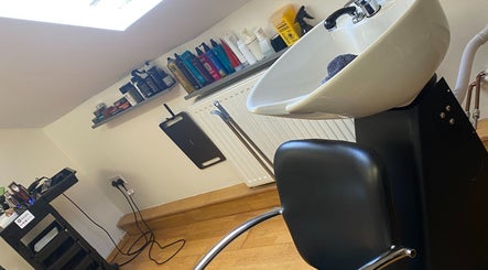 Washing area at Reece Goldsmith Hairdressing in Swineshead, England, GB with modern sink and styling products.
