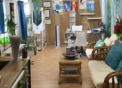 Relaxing interior of The New You Beauty and Wellness in Maclean, New South Wales, AU with lush plants and cozy seating.