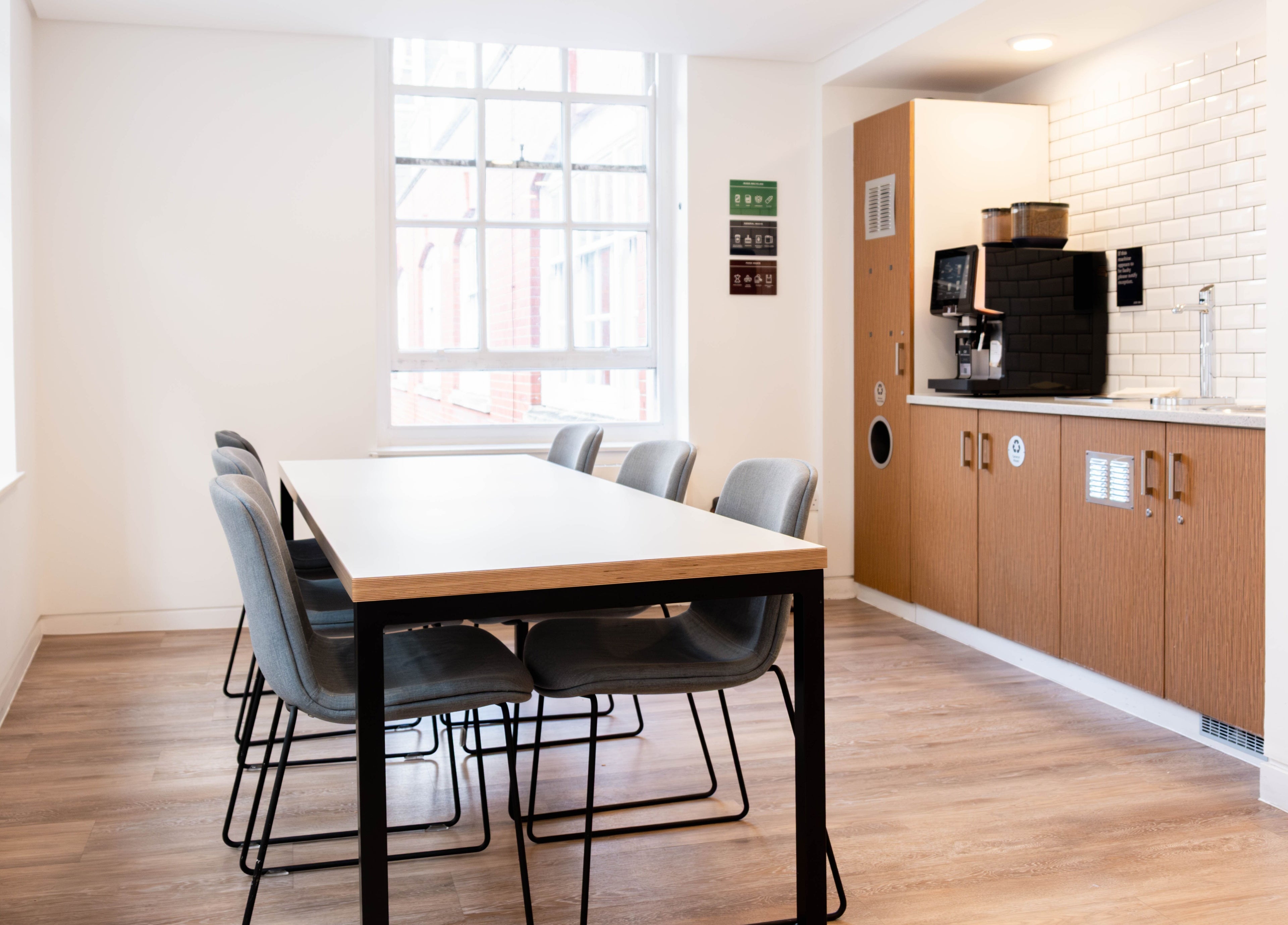 Modern meeting space at Soho Beauty & Aesthetics, London, England, GB with sleek table and coffee station.