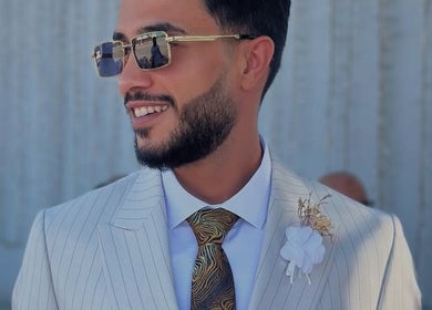 Nouh barber in Dubai, AE showcasing sleek hairstyle with sunglasses.