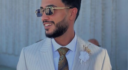 Nouh barber in Dubai, AE showcasing sleek hairstyle with sunglasses.
