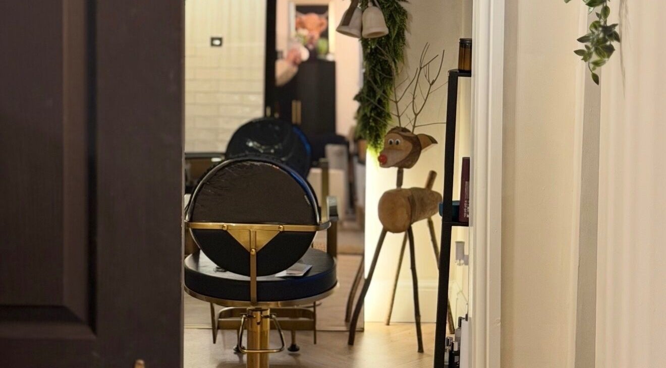 View of a cozy interior at Rural Roots Studio, Chapel-en-le-Frith, England, with salon chair and decor.