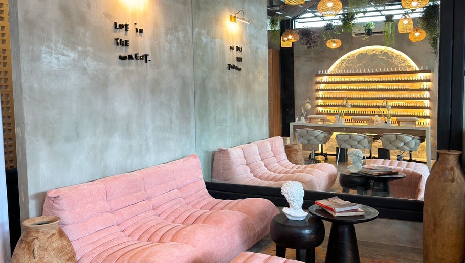 Chic lounge area at The Rustic Sun - Nelayan, Bali, Bali, ID with pink sofas and modern decor.