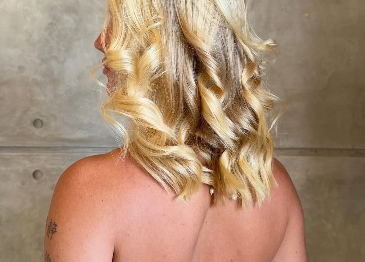 Elegant blonde curls styled at The Rustic Sun - Nelayan, Bali, Bali, ID for a radiant look.