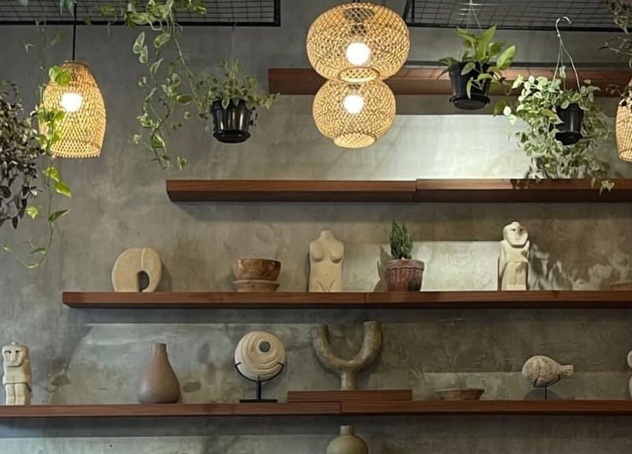 Artistic wooden shelves and hanging plants at The Rustic Sun - Nelayan, Bali, Bali, ID.