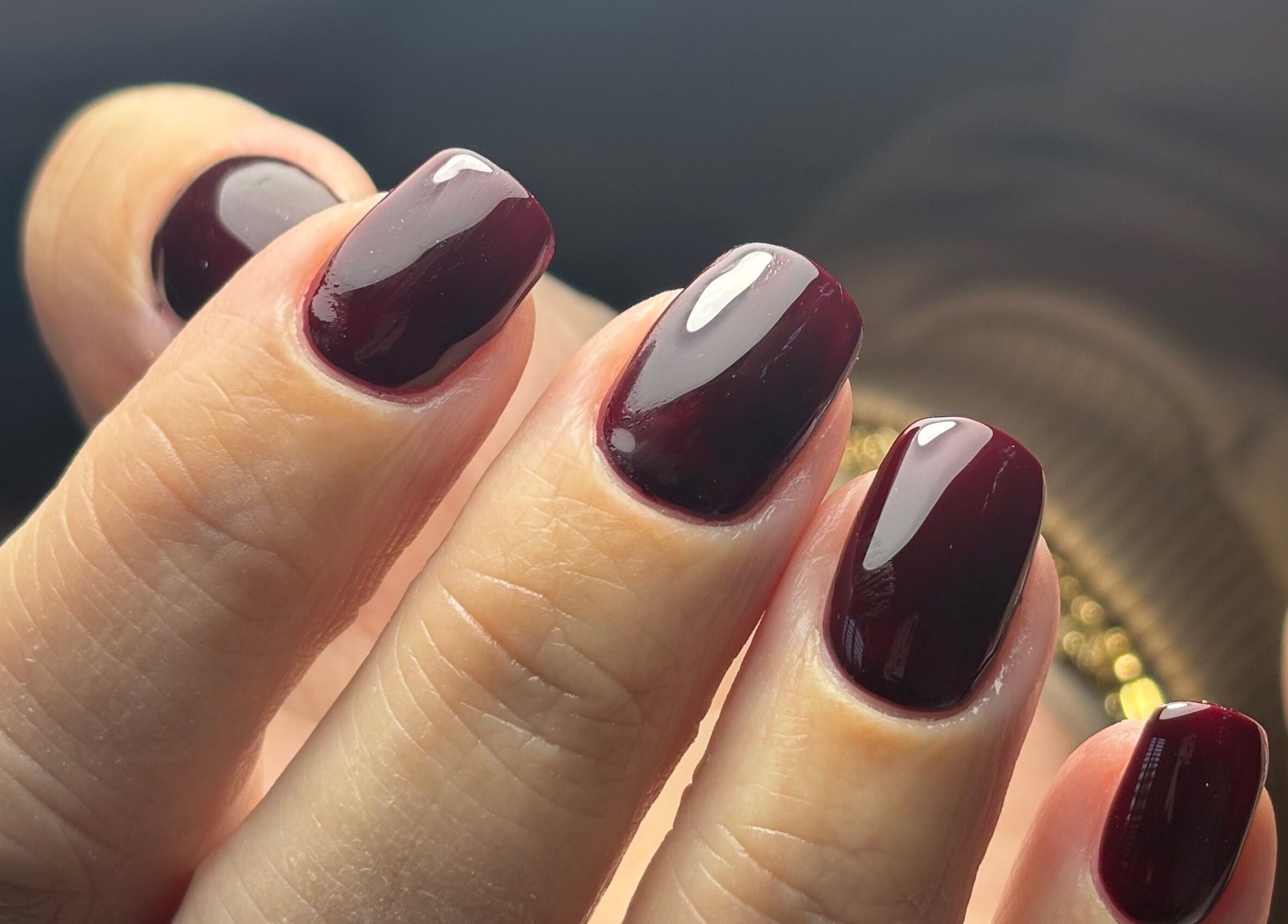 Close-up of elegant maroon manicure at Studio 1 Beauty By Zoe, Exeter, England, GB.