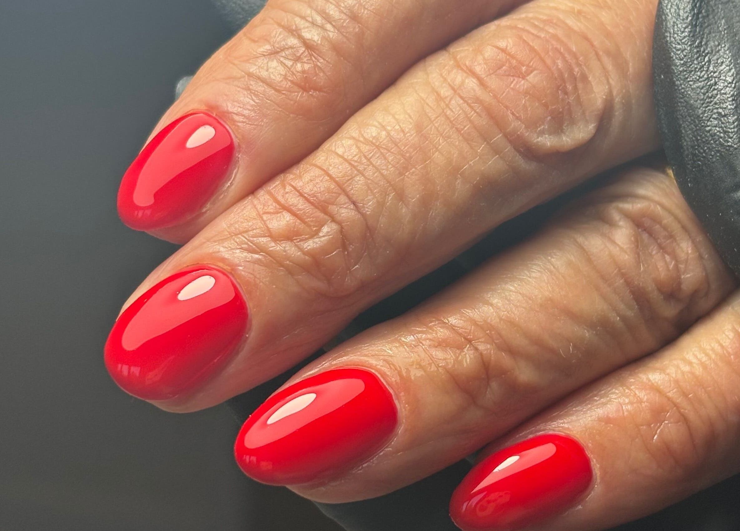 Glossy red manicure at Studio 1 Beauty By Zoe in Exeter, England, GB, showcasing vibrant nail art.