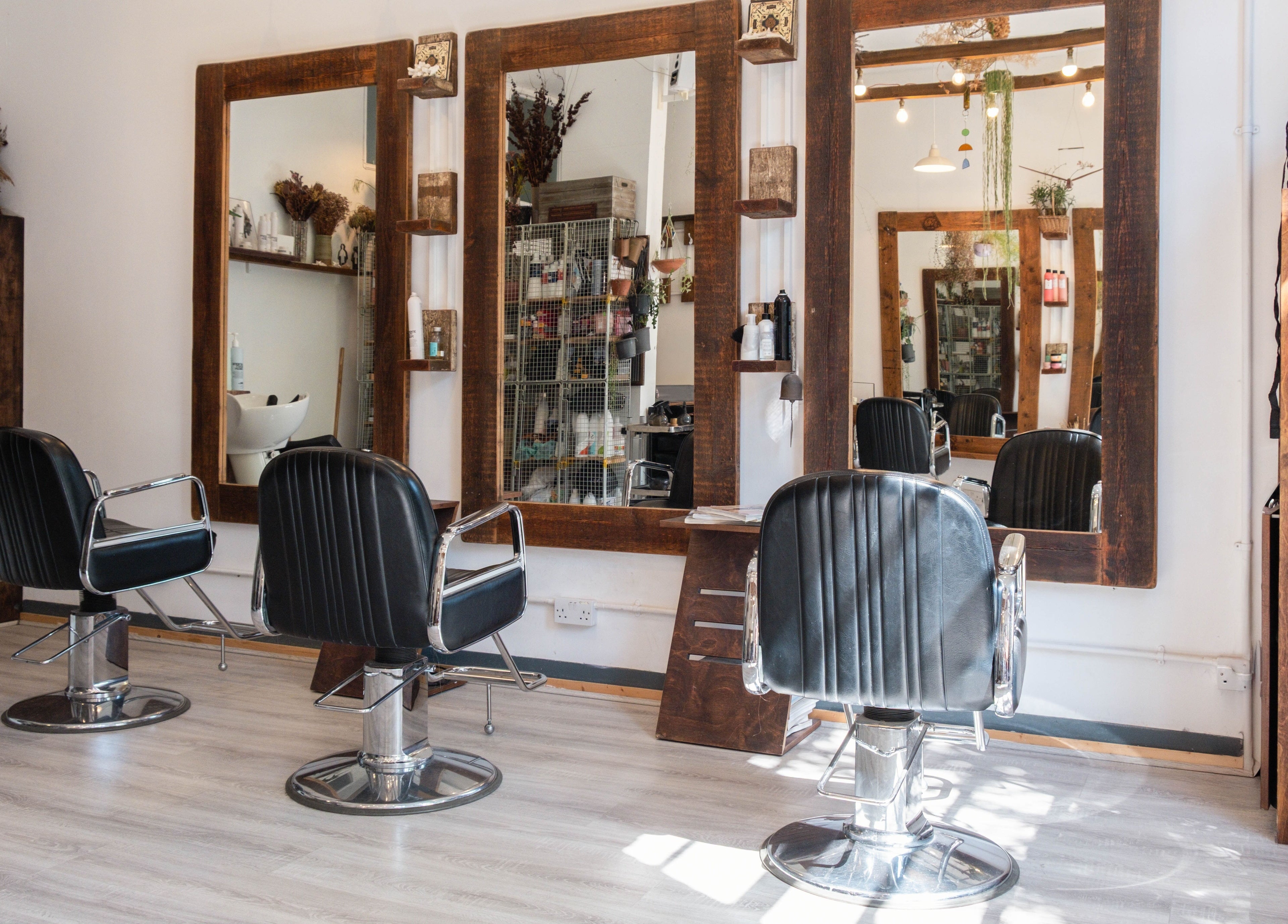 Chic and stylish interior of K Hair Studio located in London, England, GB, featuring modern salon chairs.