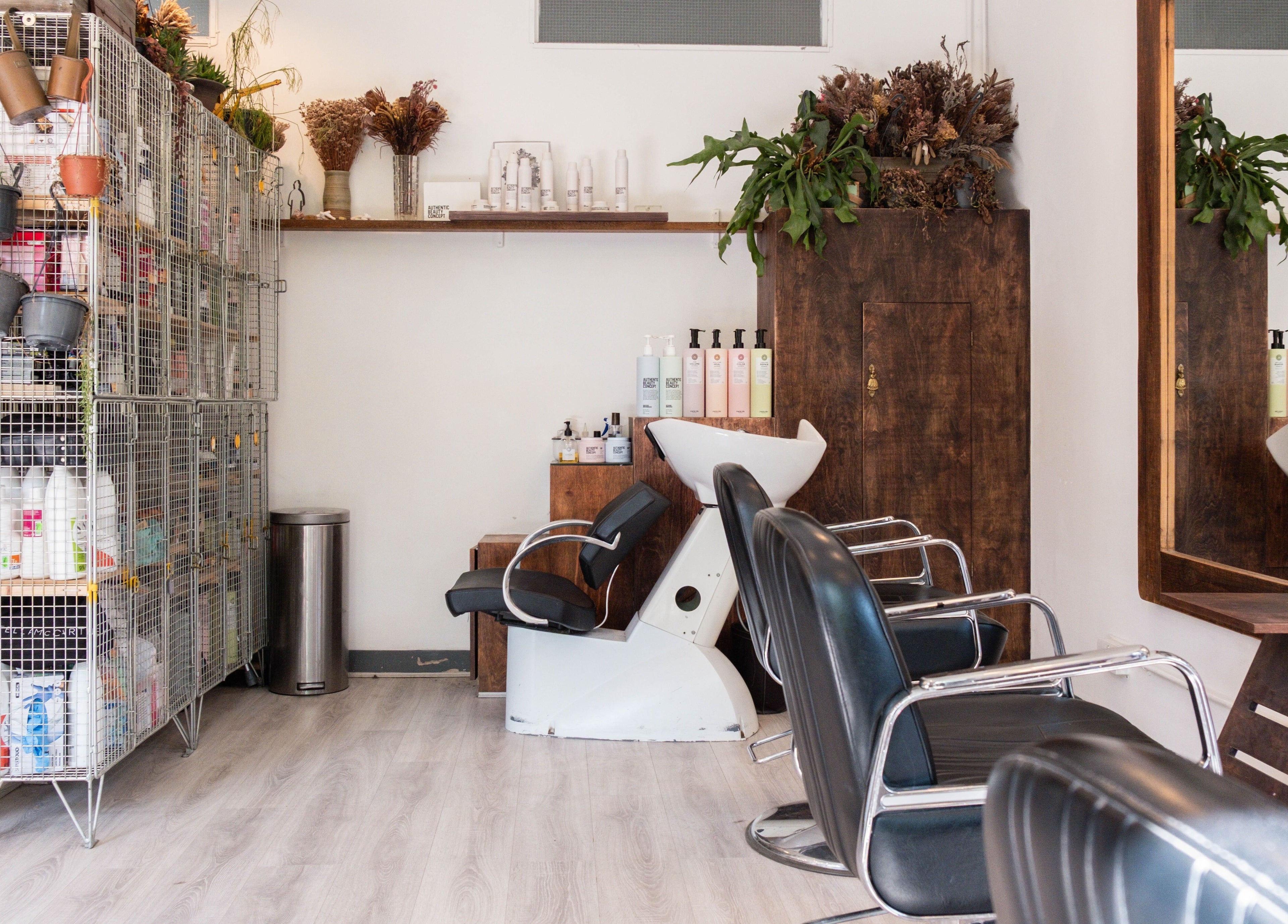 Modern chairs and hair products in K Hair Studio, London, England, GB. Stylish and welcoming ambiance.