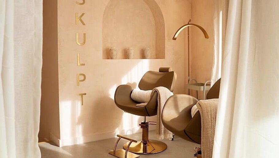 Cozy styling chair at Beauty Calls Mcr Skulpt Studios in Manchester, England, GB with soft lighting and decor.