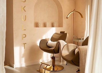 Cozy styling chair at Beauty Calls Mcr Skulpt Studios in Manchester, England, GB with soft lighting and decor.