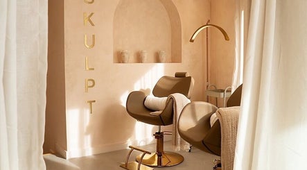 Cozy styling chair at Beauty Calls Mcr Skulpt Studios in Manchester, England, GB with soft lighting and decor.