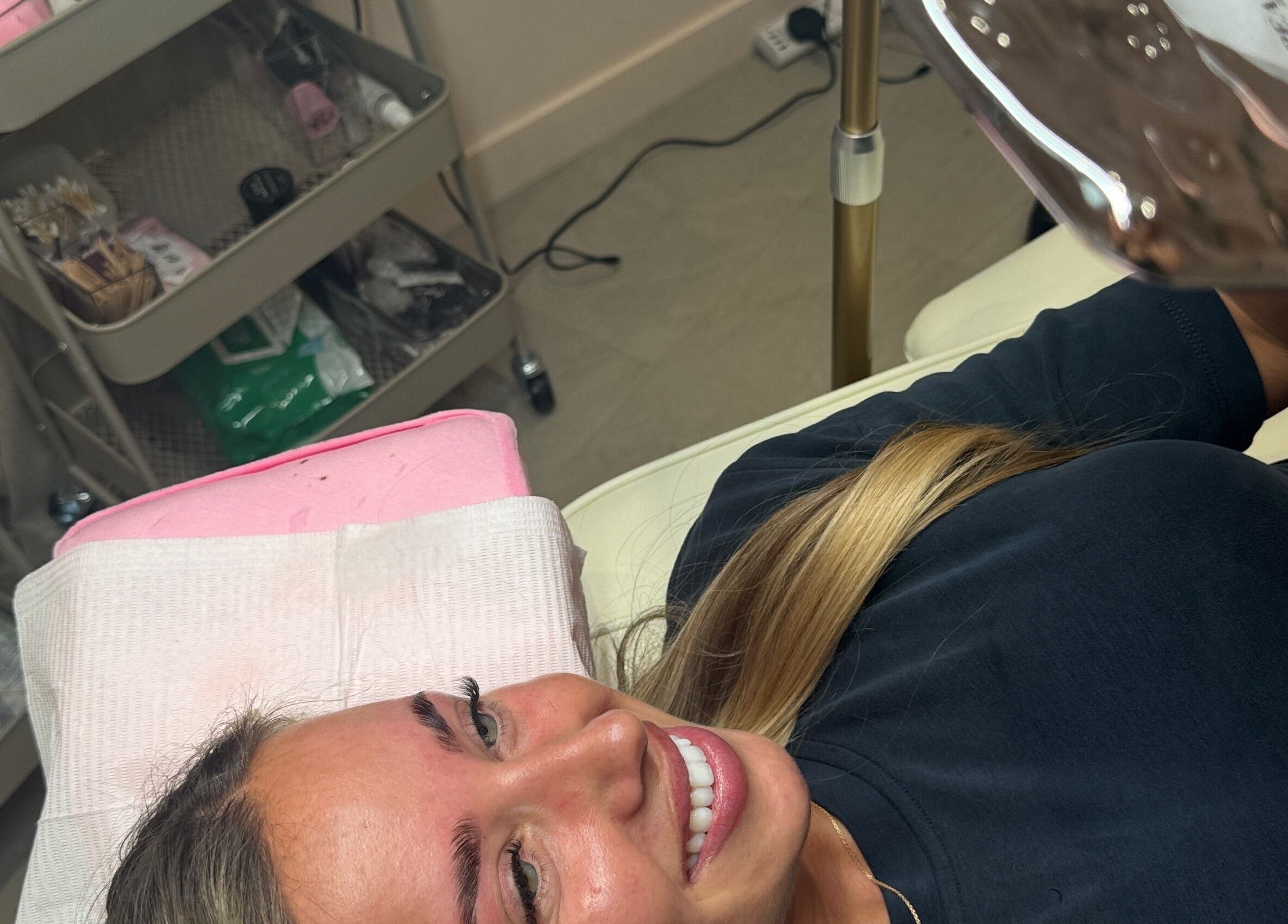 Client smiling at Beautycallsmcr | Skulpt Studios, Manchester, England, GB, showcasing beauty services.