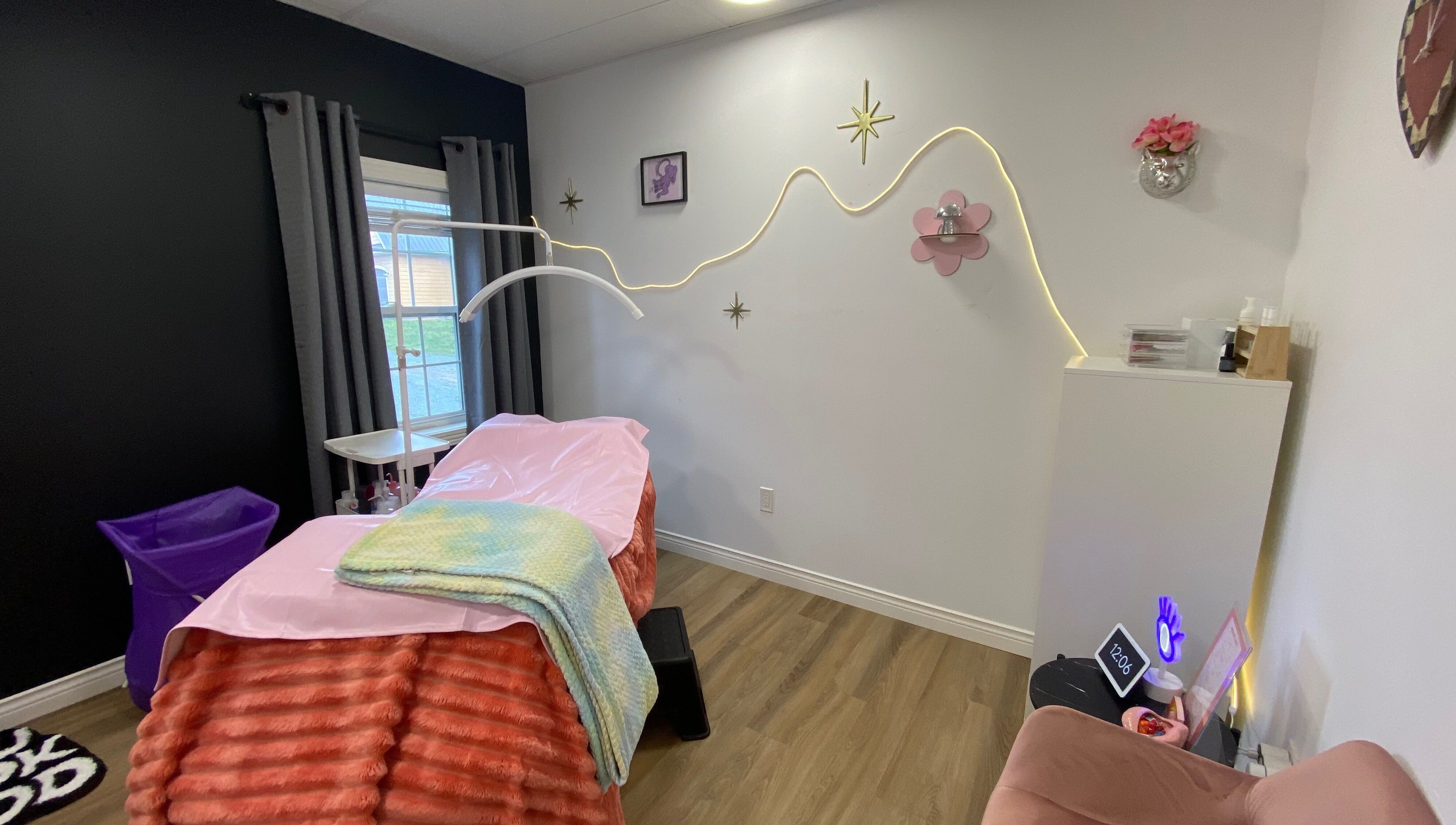 Inviting interior of Lucid Lashes, Antigonish, Nova Scotia, CA with a pink treatment bed and stylish decor.