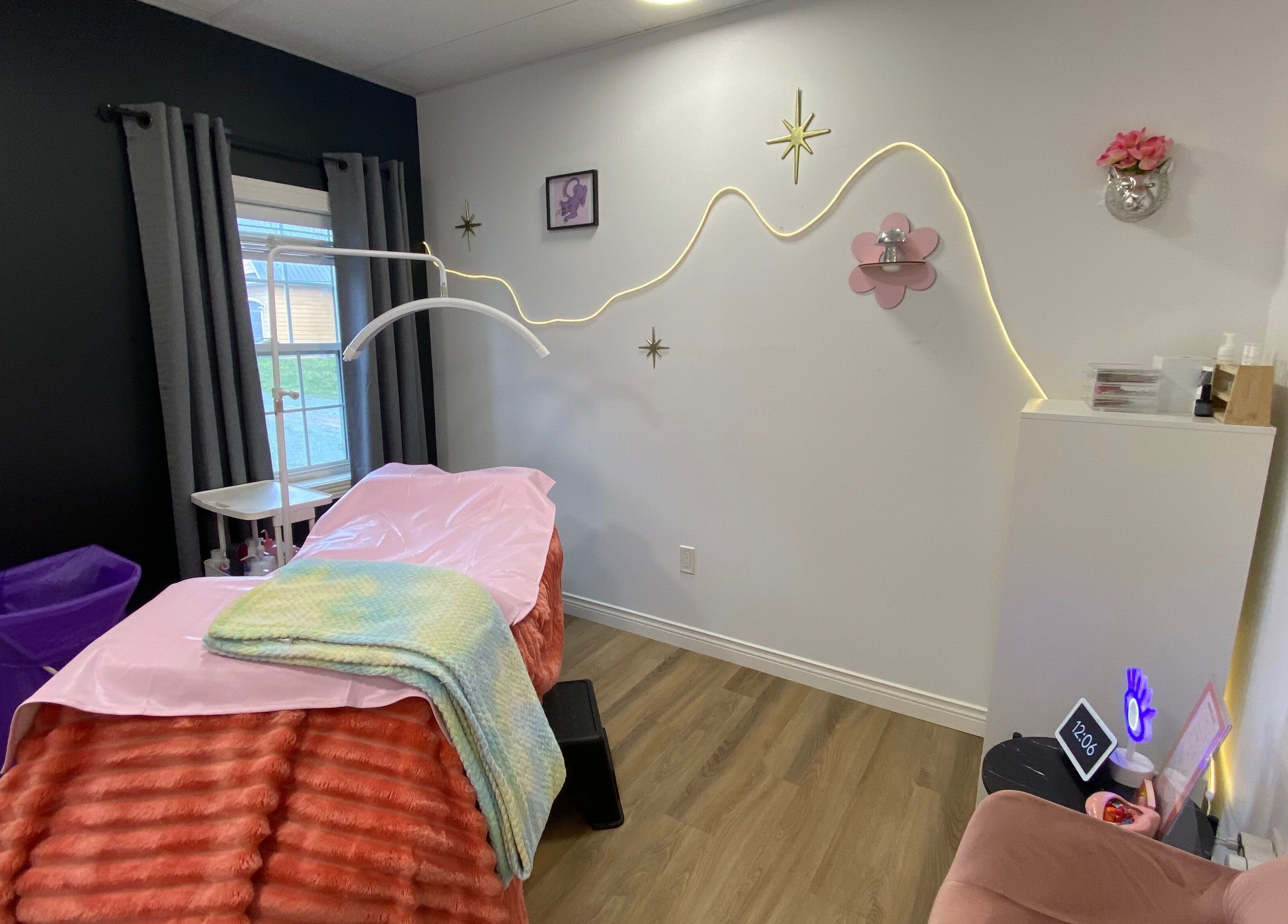 Inviting interior of Lucid Lashes, Antigonish, Nova Scotia, CA with a pink treatment bed and stylish decor.