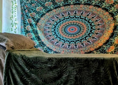 Decorative massage room at New Leaf Massage in Brandon, England, GB with colorful tapestry.