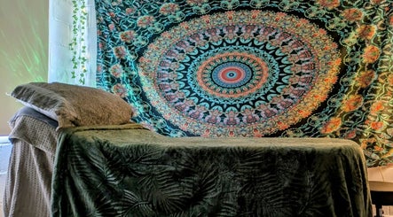 Decorative massage room at New Leaf Massage in Brandon, England, GB with colorful tapestry.