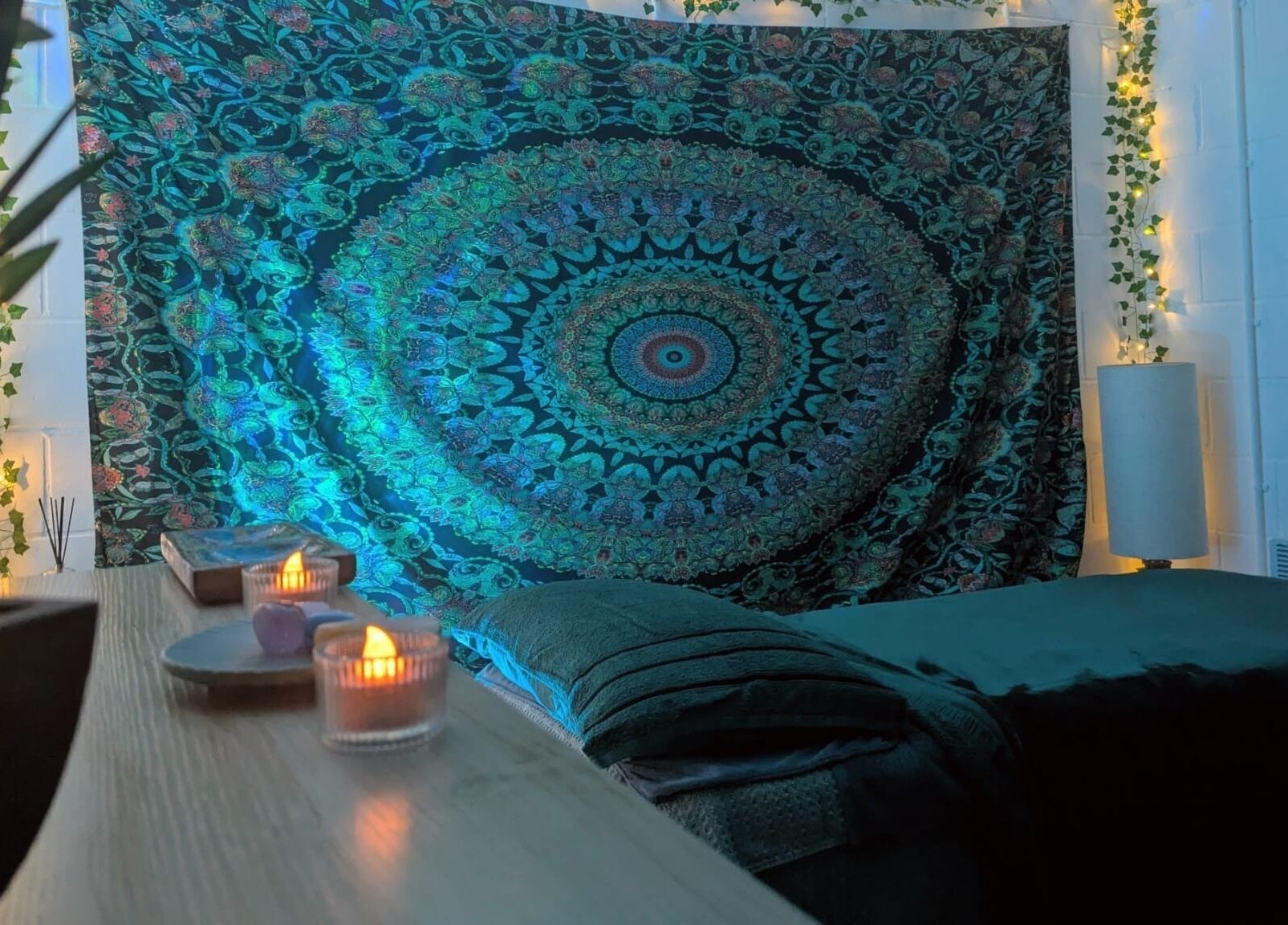 Cozy massage room at New Leaf Massage, Brandon, England, GB featuring ambient lighting and vibrant tapestry.
