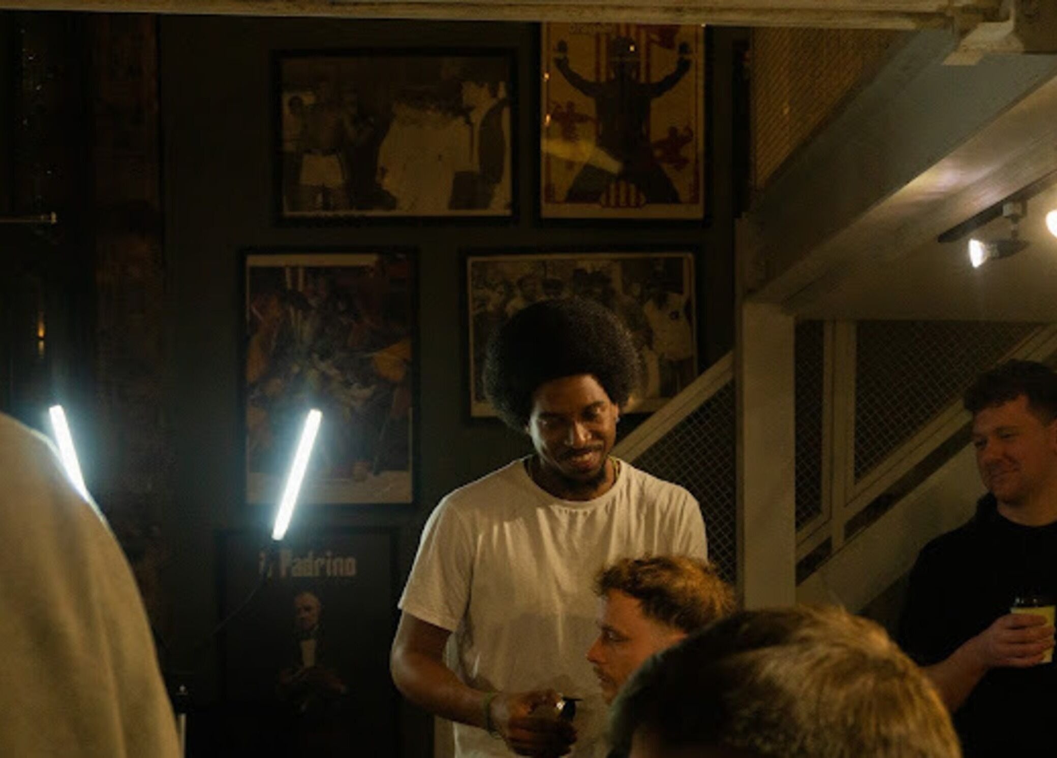 Stylists and customers at Jefe's Barbers in Manchester, England, GB, enjoying a relaxed atmosphere.