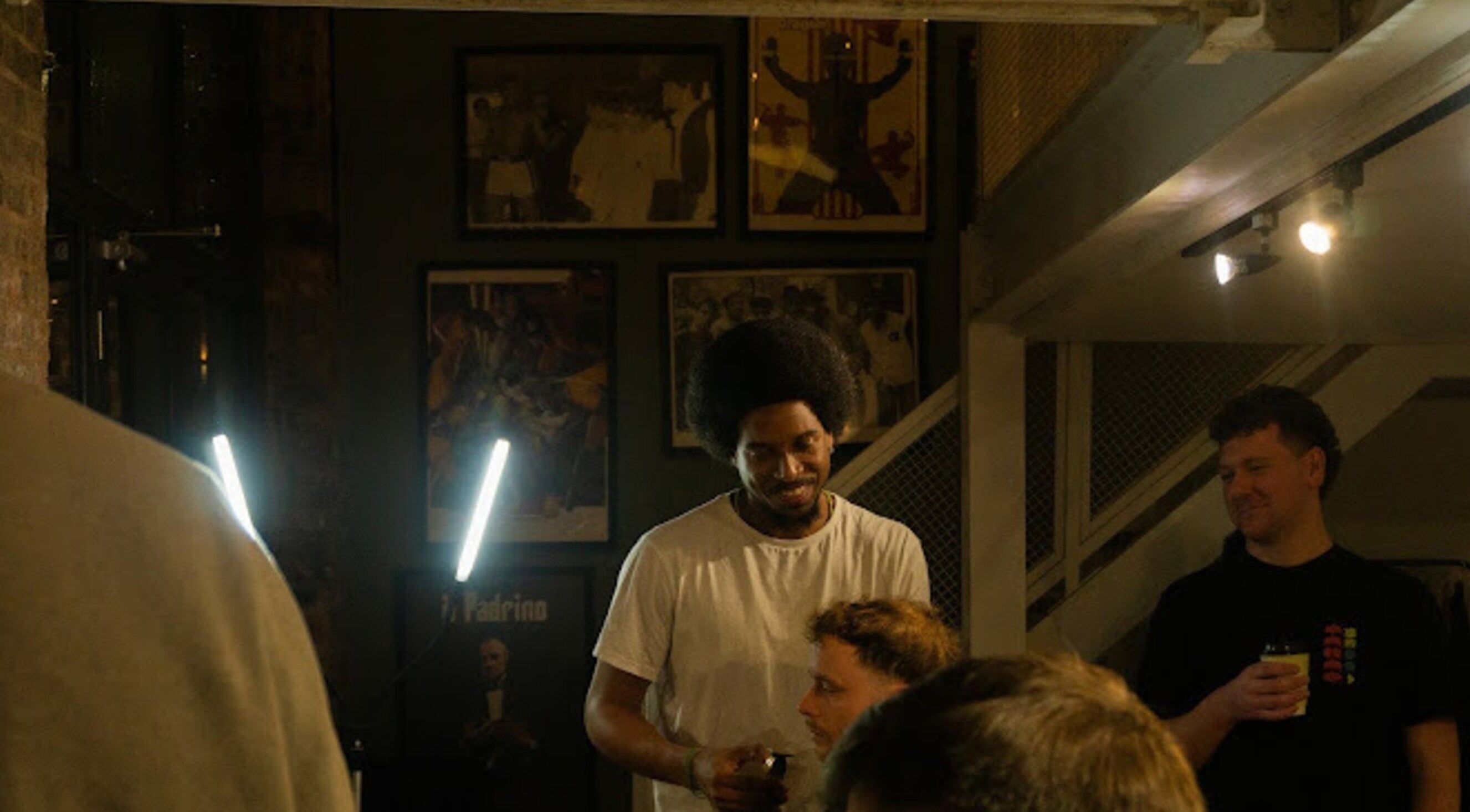 Stylists and customers at Jefe's Barbers in Manchester, England, GB, enjoying a relaxed atmosphere.