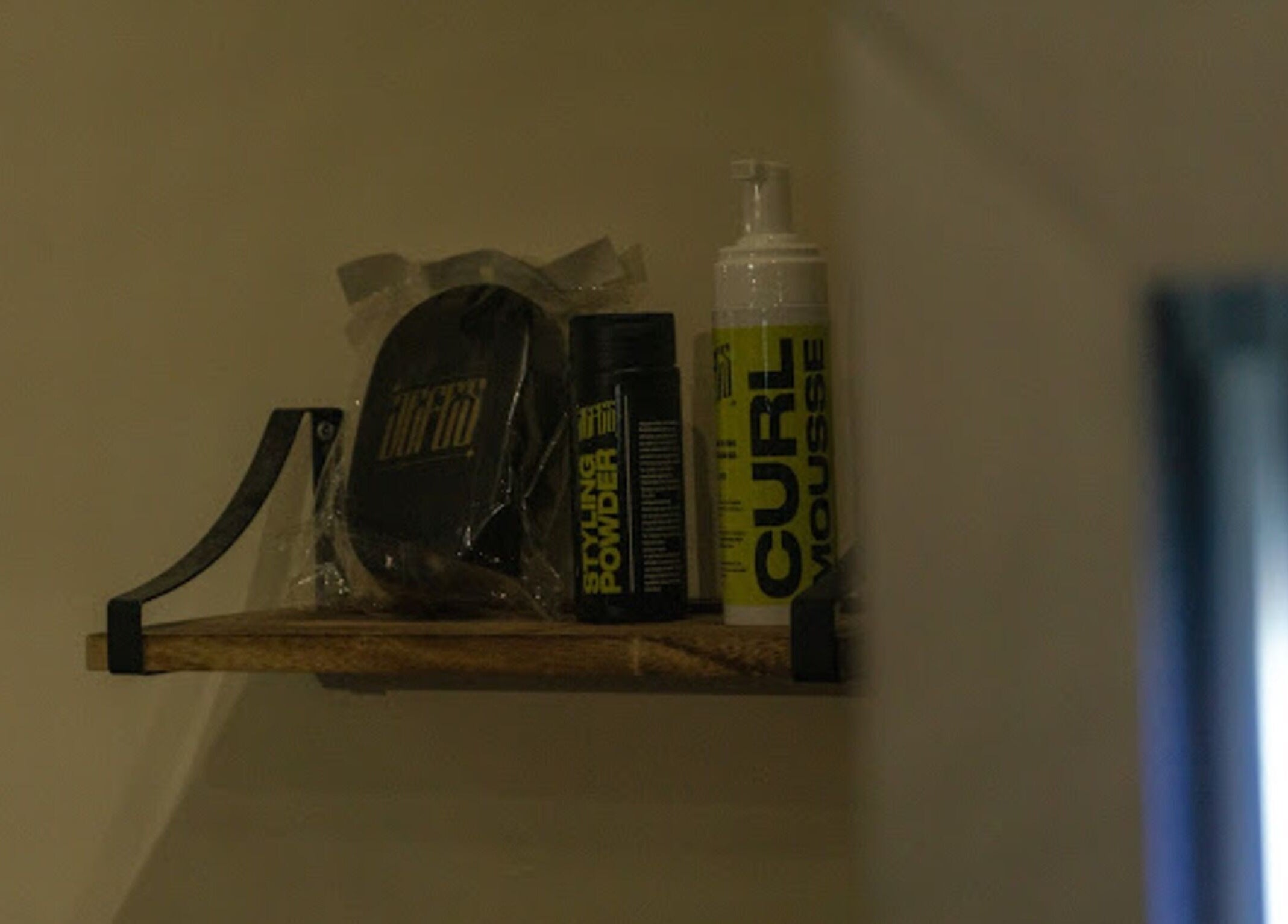 Hair styling products on a shelf at Jefe's Barbers in Manchester, England, GB.