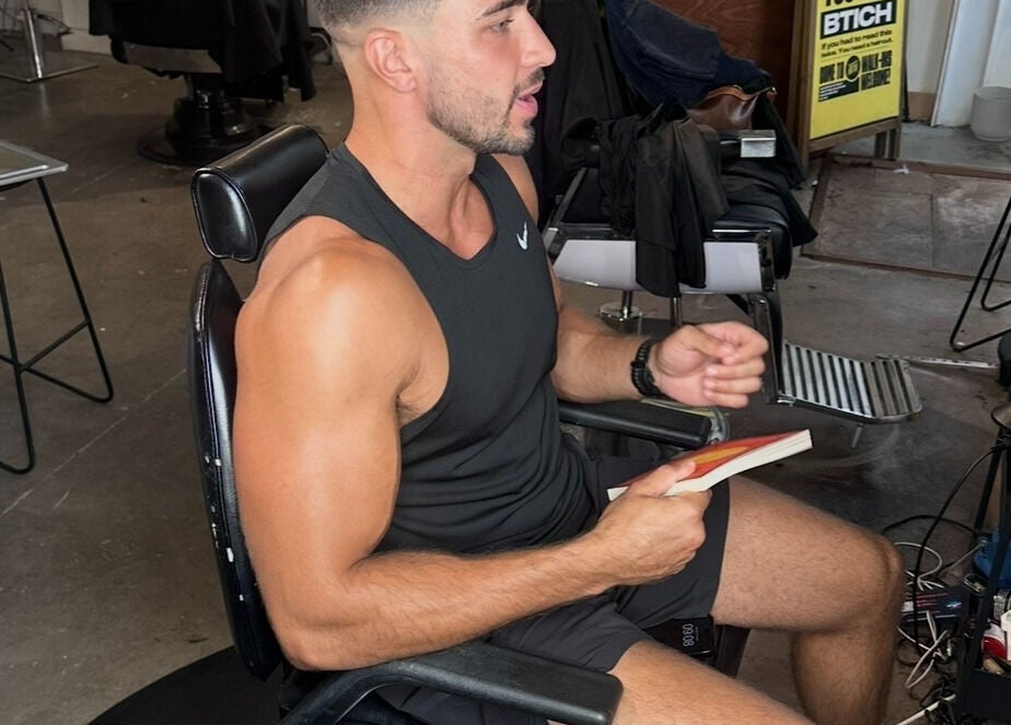 Person reading in a modern interior at Jefe Barbers - Stockport, Stockport, England, GB.