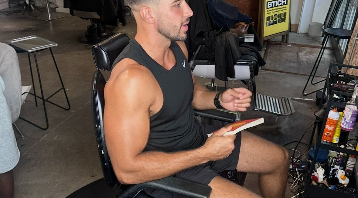 Person reading in a modern interior at Jefe Barbers - Stockport, Stockport, England, GB.